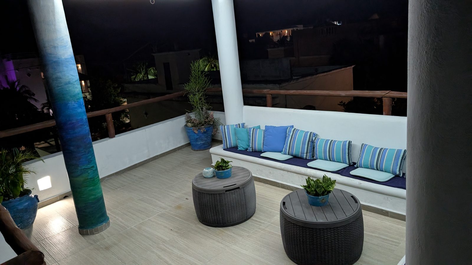 The rooftop terrace, with built-in seating and blue cushions